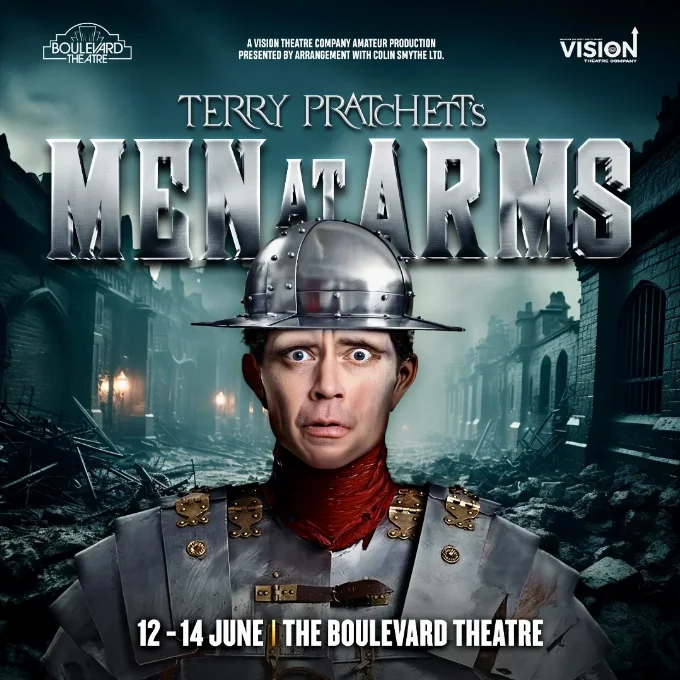 Production poster showing a worried looking watchman standing in the middle of a dark road with the words Terry Pratchett's Men at Arms across the middle