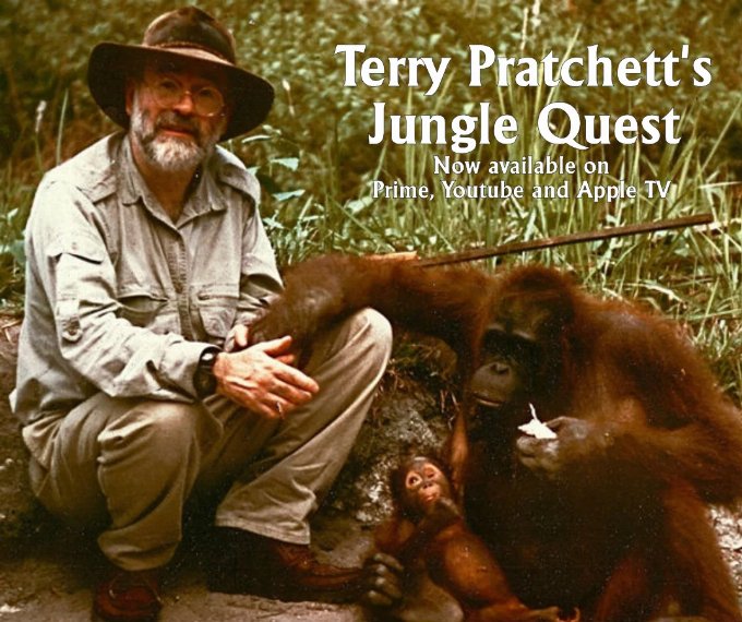 Image of Terry Pratchett with a female Orangutan and her baby